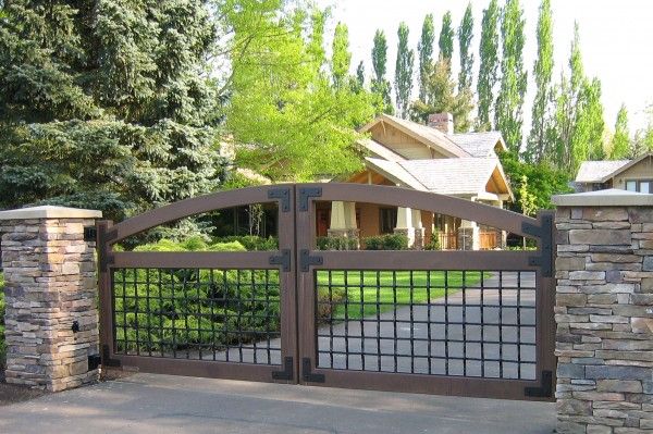 a gated driveway leading to a house