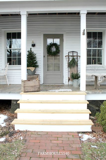 a porch with steps leading to the front door