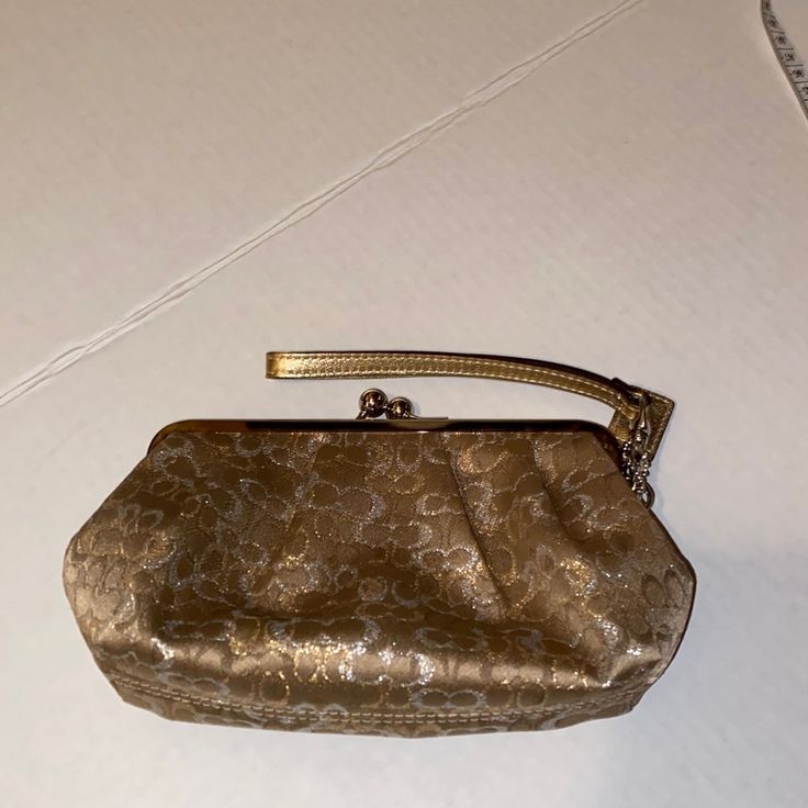 Never Used This Bag But Don’t Have The Original Tags To It. It’s A Gold Signature Clutch Bag. Can Fit Your Phone, Keys, And Other Small Items. Chic Coach Bag With Zipper Pouch, Elegant Coach Bag With Zipper Pouch, Gold Rectangular Coach Bag, Elegant Satchel Cosmetic Bag, Coach Bags With Zipper Pouch For Formal Occasions, Elegant Handheld Shoulder Bag With Zipper Pouch, Elegant Party Bag With Zipper Pouch, Elegant Party Bags With Zipper Pouch, Gold Clutch Coin Purse For Travel