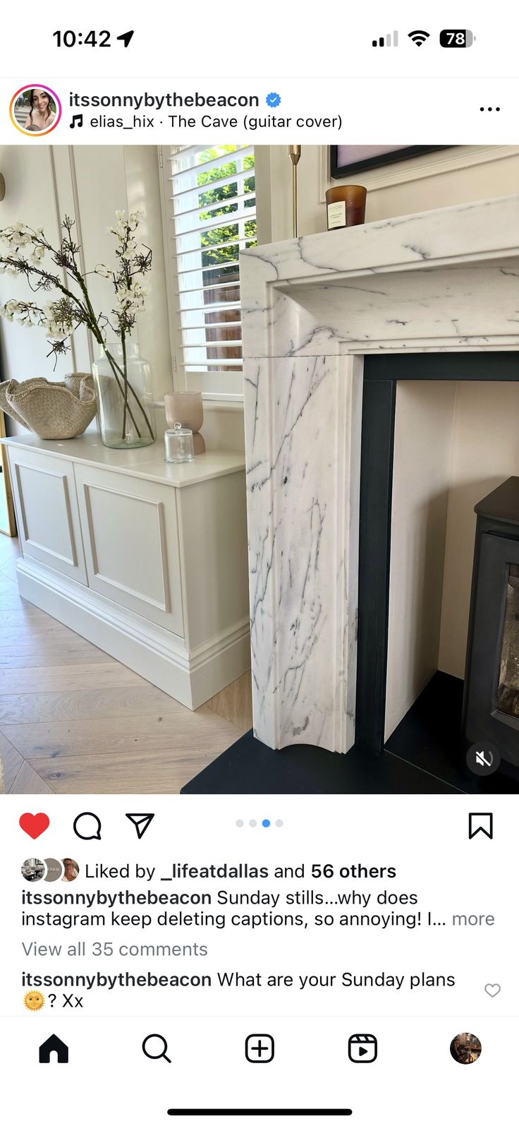 an instagramted photo of a fireplace with white marble surround and mantels