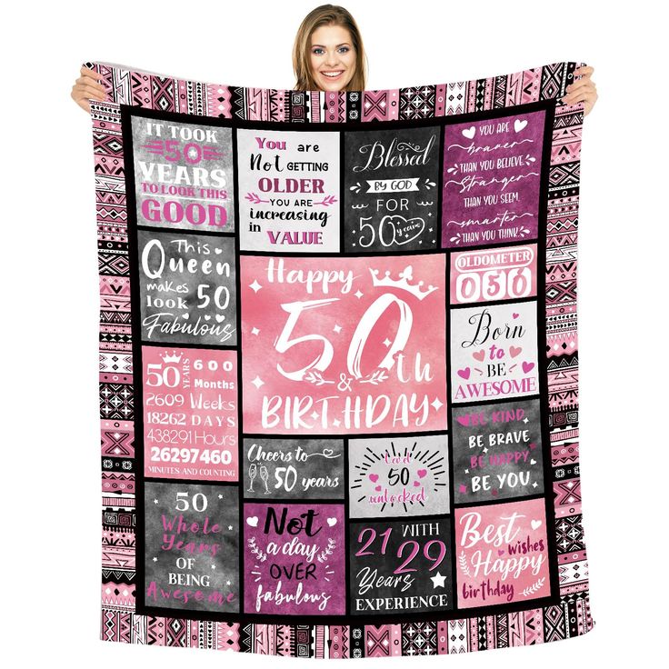 a woman holding up a pink and black blanket with the words happy 50th on it