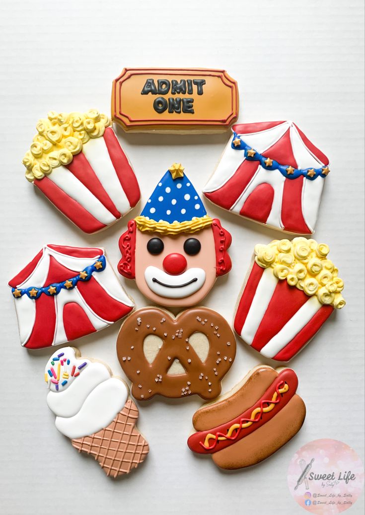 decorated cookies are arranged in the shape of clowns, hot dogs and circus tents