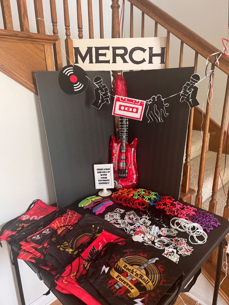 there is a table with many items on it and a sign that says merch