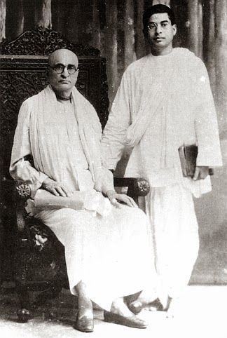 two men standing next to each other on a chair