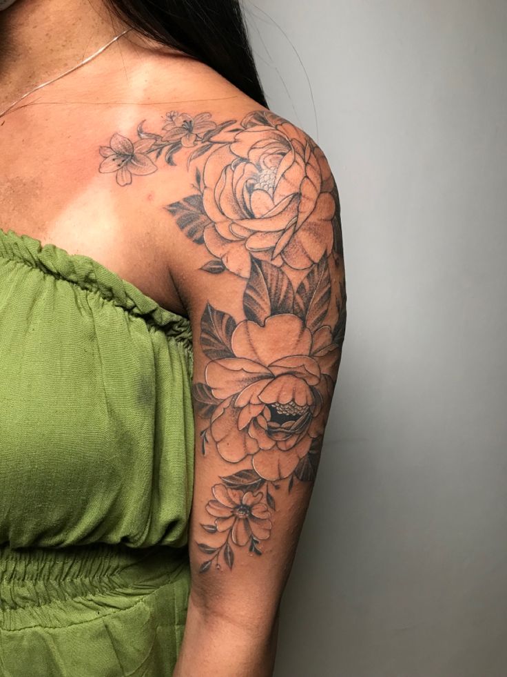 a woman with a flower tattoo on her arm