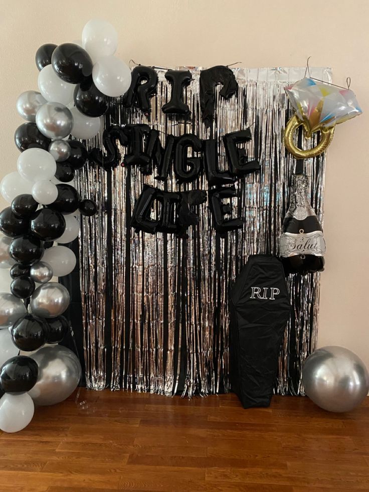 a black and white party decoration with balloons