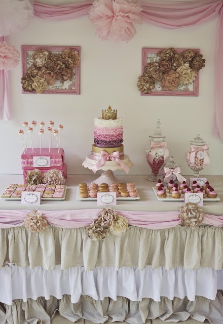 a table topped with lots of cakes and desserts