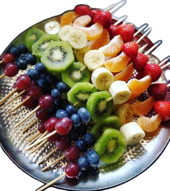 fruit skewers are arranged on a metal plate