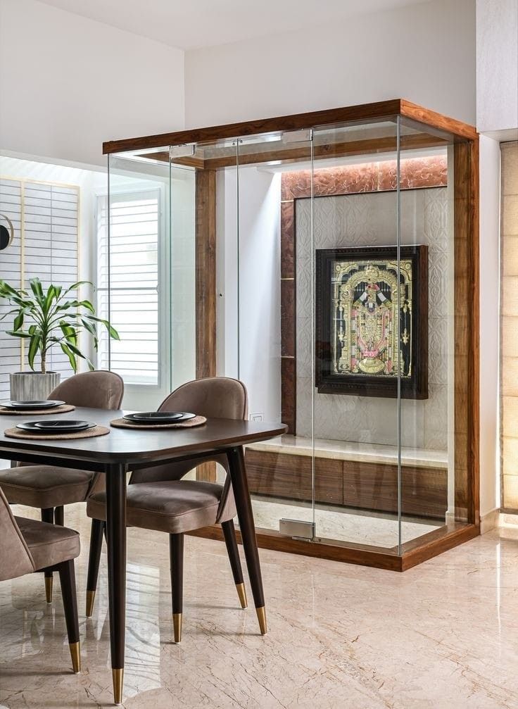 a dining room table and chairs in front of a glass wall with a painting on it