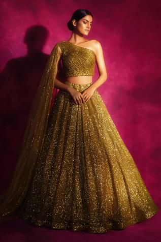 Dull gold lehenga with sequin embroidered detail. Paired with one shoulder sequin embroidered and attached veil blouse.
Component: 2
Embroidered
Neckline: Asymmetric
Sleeve Length: Asymmetric
Fabric: Net
Color: Gold
Attached sequin work veil - Aza Fashions Dull Gold Lehenga, Shoulder Veil, Vani Vats, Gold Lehenga, Lehenga Blouse Designs, Fancy Blouse, Indian Wedding Wear, Lehenga Blouse, Designer Outfits