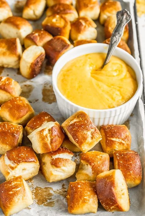 rolls and dip on a baking sheet ready to be eaten with the dipping sauce in a small white bowl