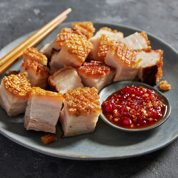 sushi on a plate with chopsticks and sauce