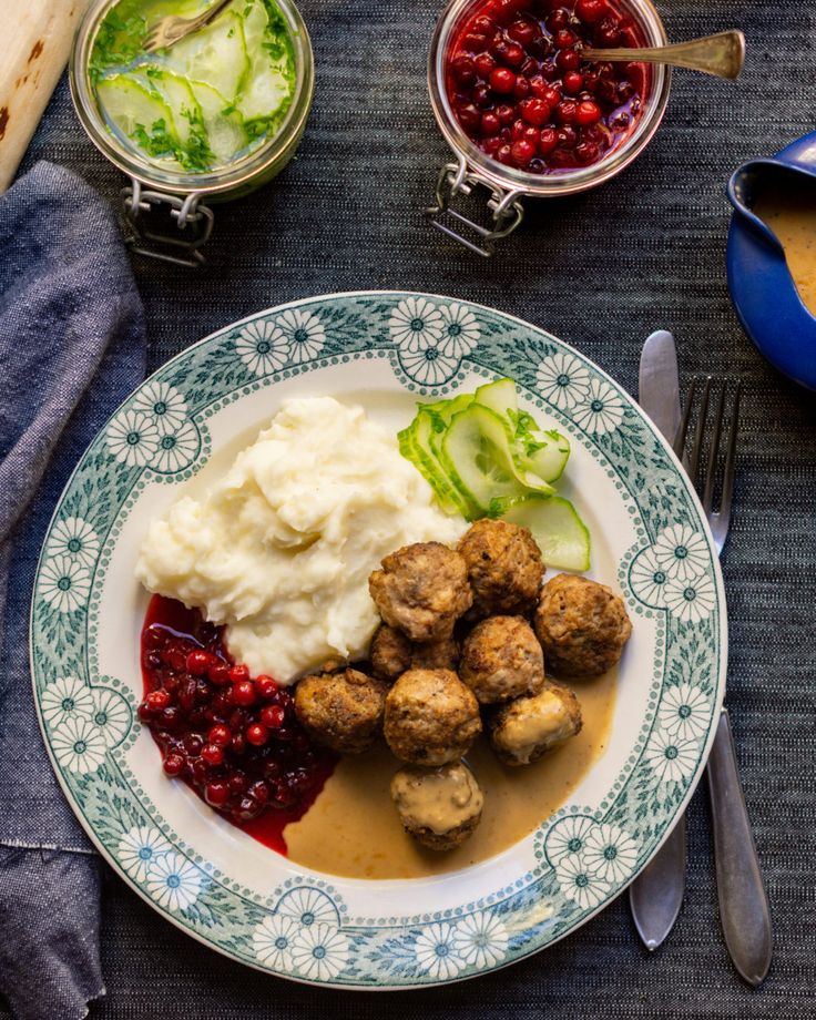 a plate with meatballs, mashed potatoes and cranberry sauce on it