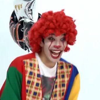 a man with red hair and clown makeup