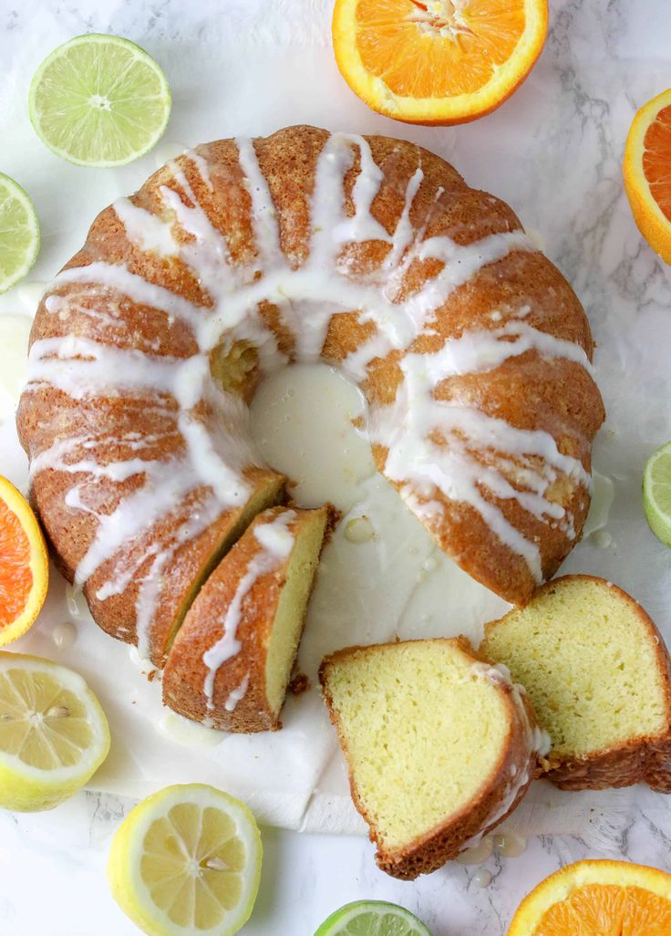 a bundt cake with icing and sliced oranges