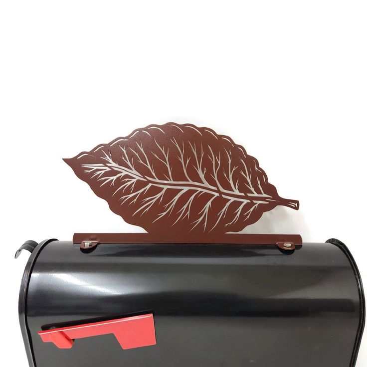 a mailbox with a leaf on it