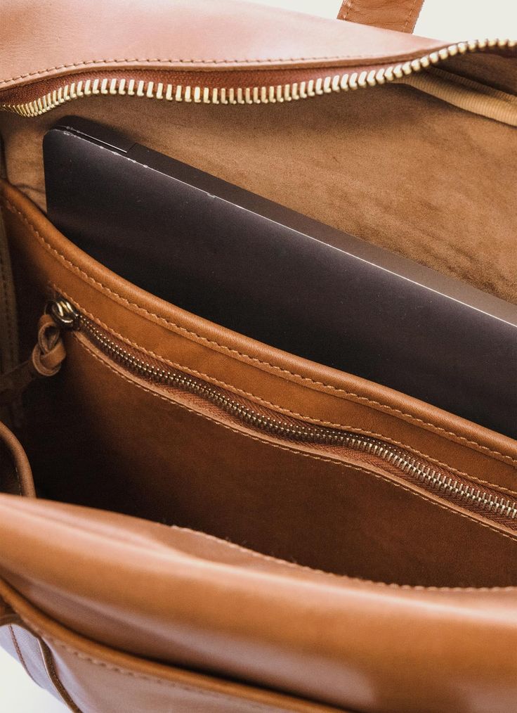 The Woodward Briefcase is the perfect companion for your daily commute. It's made of full-grain leather with solid brass hardware, which will last for years. Plus, it has a dedicated pocket for your laptop and a zipper pouch to store all your other essentials. And if you need to carry it over your shoulder, the adjustable strap makes it easy. Best of all, you can add a monogram to make it uniquely yours. All this with a lifetime guarantee to boot. Materials Features Dimensions 100% Full-Grain Le Leather Laptop Bag For On-the-go, Timeless Leather Lined Laptop Bag For Travel, Classic Leather Backpack With Smooth Grain For Travel, Classic Leather Backpack For Daily Use, Classic Rectangular Leather Backpack For Everyday, Classic Leather Backpack With Luggage Sleeve For Office, Travel Leather Backpack With Vegetable Tanned Leather, Classic Laptop Backpack, Functional Leather Backpack For Office