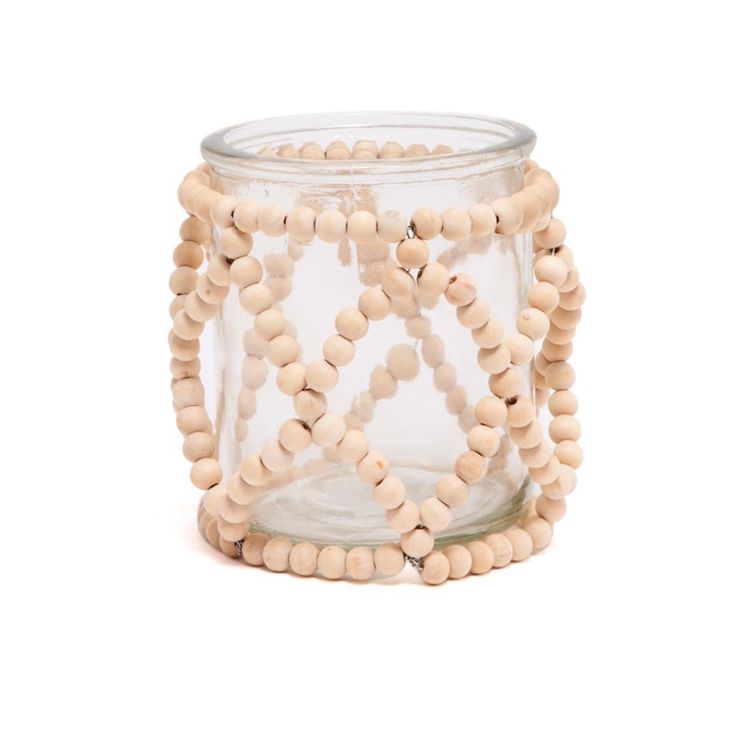 a glass jar filled with wooden beads