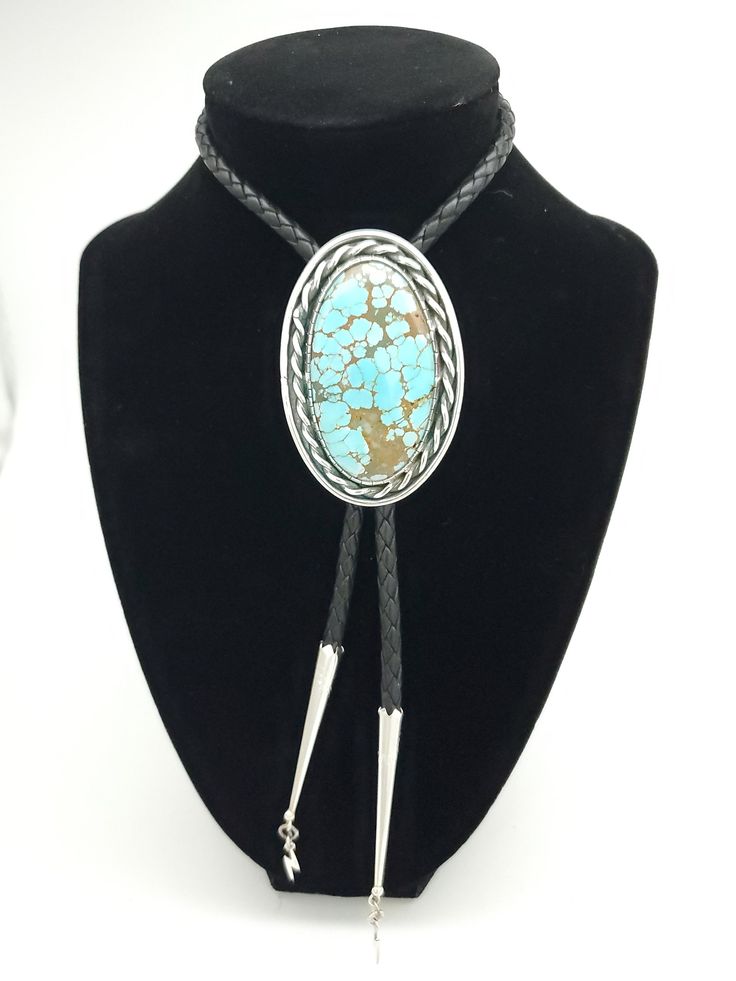 Number 8 Mine,  Oldstock Turquoise Bolo Tie. This one is on the larger size, with some really neat details.  This piece features a gem grade Turquoise cabochon, set in sterling. Simple and timeless, One of the many different looks from this mine. All of the turquoise chosen for my bolo ties is absolutely some of the best old stock that can be found. Always priced fairly to ensure value, these are heirloom caliber stones. This features a larger 5mm leather braided cord with sterling tips. Those a Artisan Turquoise Jewelry For Formal Occasions, Elegant Turquoise Concho Jewelry, Adjustable Western Style Gemstone Jewelry, Luxury Silver Concho Jewelry, Elegant Blue Concho Jewelry, Elegant Blue Jewelry With Concho Detail, Artisan Turquoise Oval Cabochon Jewelry, Elegant Adjustable Turquoise Gemstone Necklace, Adjustable Turquoise Luxury Jewelry