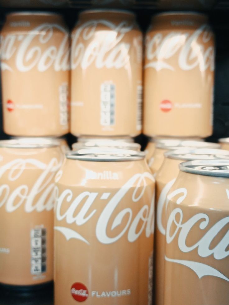 several cans of coca - cola are stacked on top of each other