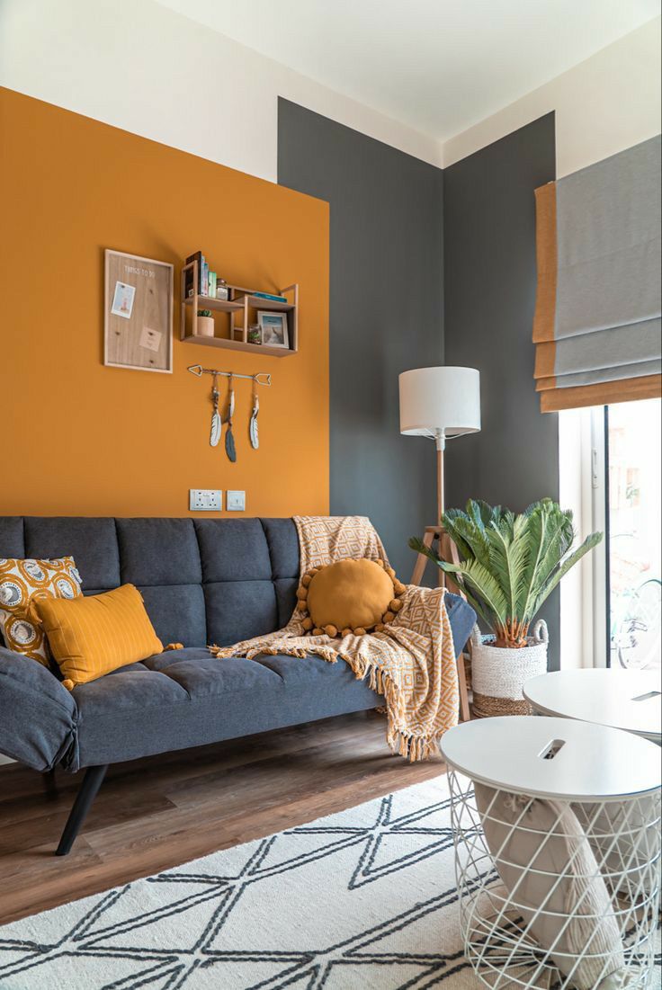 a living room with orange and gray walls