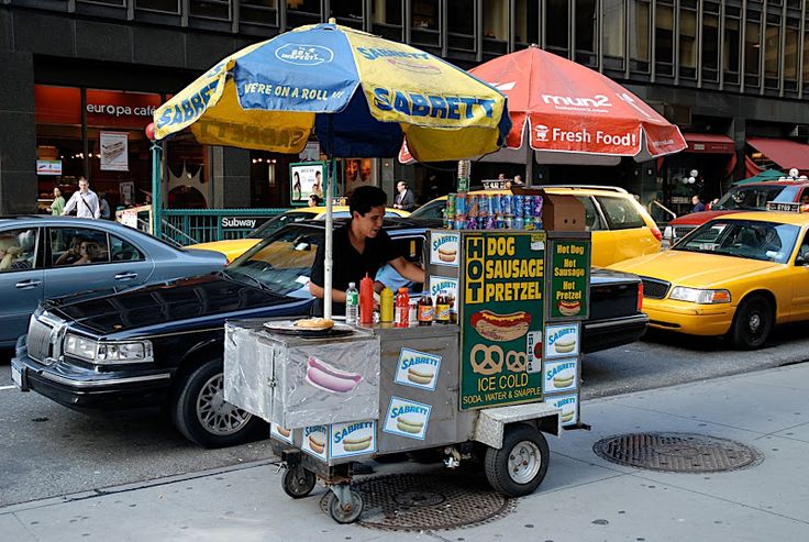 a street vendor selling food on the sidewalk