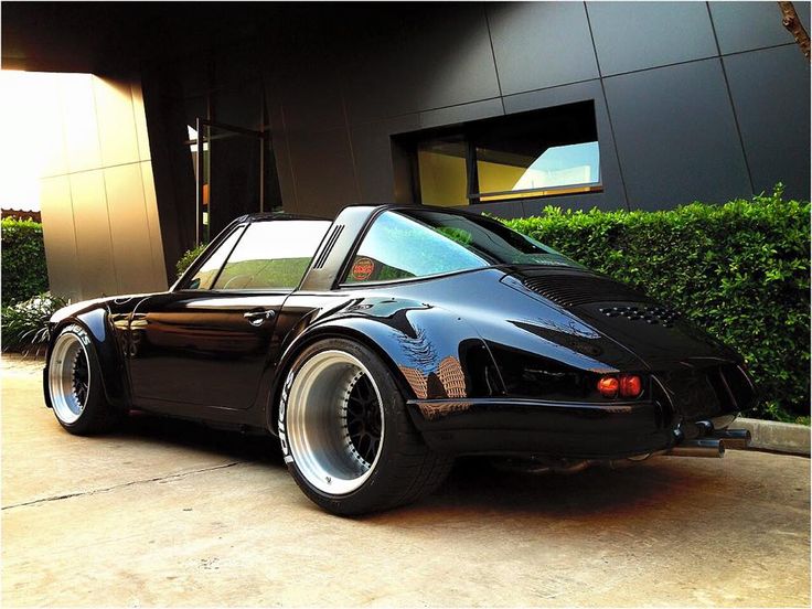 a black sports car parked in front of a building