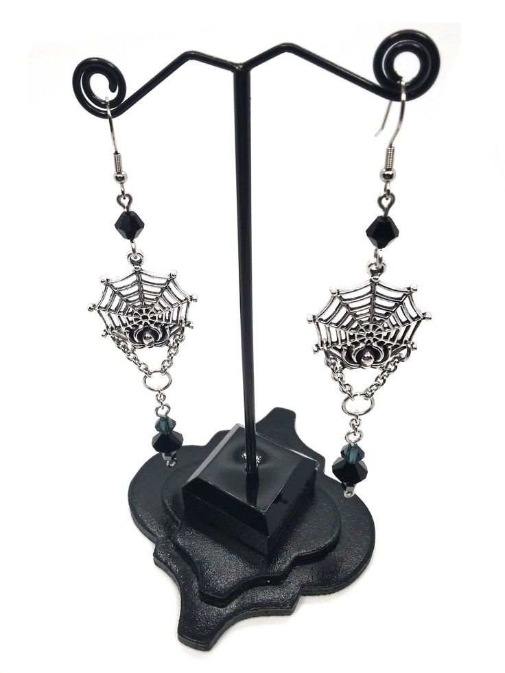 Made to Order! This earring set features a spider on its web. Perhaps it is reeling in its tangled prey? They can be worn with Gothic, fantasy inspired, steampunk or any other outfits you wish. This elegant design is the perfect pair with one of my necklaces or rosary chains! They also go really well with layers of stacked silver statement necklaces. These earrings make a perfect gift for someone who loves spiders and insects or ornate silver toned jewelry. Each earring weighs approx. .2 oz. ﻿Th Fantasy Metal Earrings With Ear Wire, Gothic Earrings For Costume Party, Fantasy Metal Earrings For Halloween, Steampunk Jewelry For Halloween Cosplay, Fantasy Dangle Earrings For Halloween, Fantasy Earrings For Halloween Gift, Halloween Fantasy Dangle Earrings, Handmade Metal Witchy Earrings, Black Fantasy Dangle Jewelry