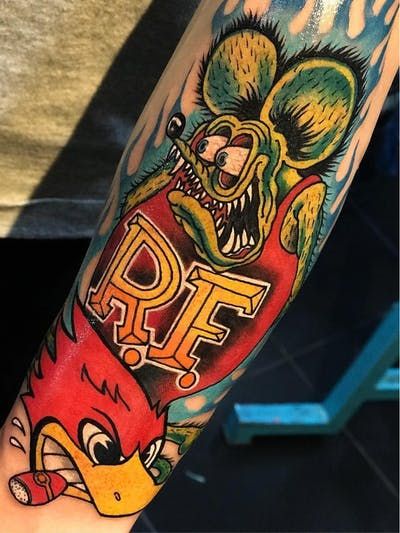 a man with a tattoo on his arm has an angry bird and the word pff