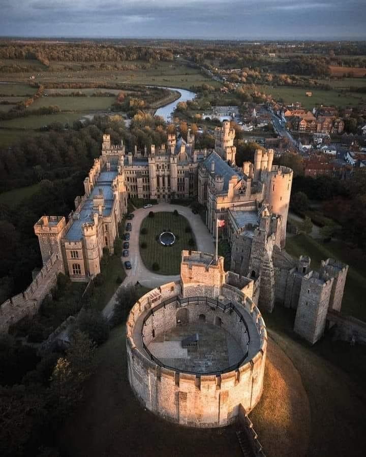 an aerial view of a castle in the evening