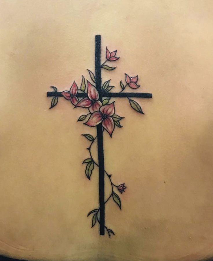 a cross with flowers on the back