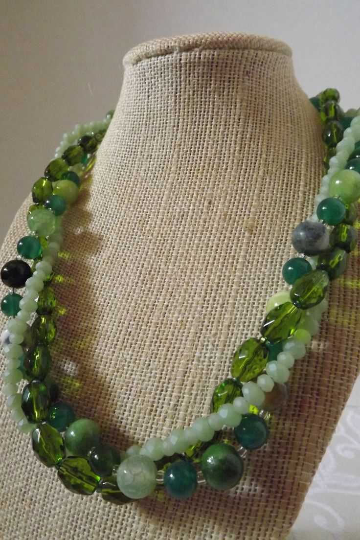 "Cracked green agate, jade, cats' eye, and faceted stones are gorgeous in this fresh design. This multi strand necklace is 19\" and is finished with a silver hook clasp. The design can also be worn untwisted.  All orders come in a beautiful gift box ready for giving along with a special \"thank you\" gift. Thank you for sharing my love of jewelry." Green Multi-strand Beaded Necklace With Natural Stones, Green Multi-strand Necklace With Natural Stones, Green Faceted Jade Beaded Necklaces, Green Double Strand Beaded Necklace, Green Faceted Jade Beaded Necklace, Adjustable Green Double Strand Necklace, Green Onyx Necklace With Faceted Beads, Green Double Strand Necklace With Faceted Beads, Green Agate Jewelry With Faceted Beads