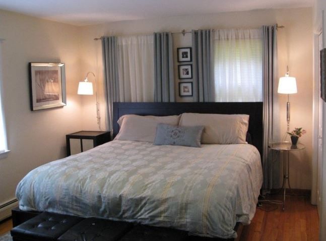 a large bed in a bedroom next to two lamps