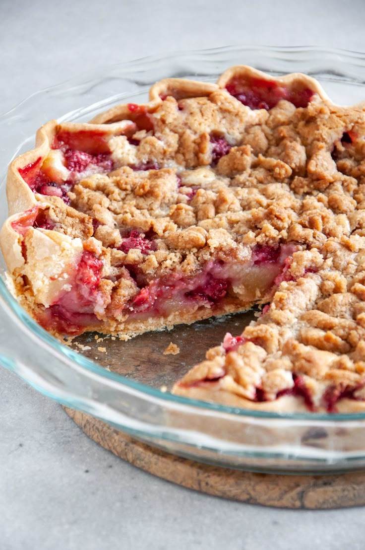 a pie that has been cut in half on a glass plate with one slice taken out