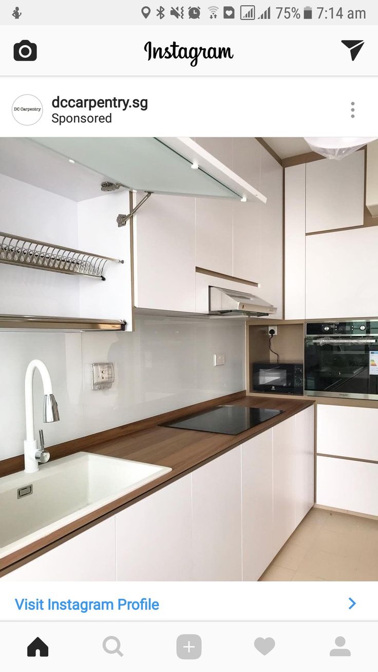 an instagram photo of a kitchen with white cabinets and wood counter tops, along with the words instagram