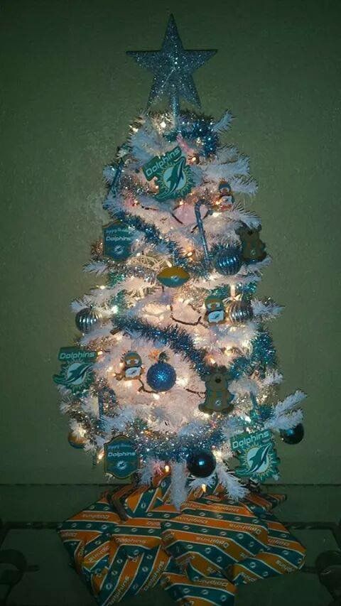 a white christmas tree with blue and green ornaments