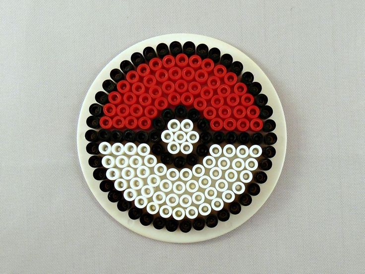 a white plate topped with lots of black and red beads