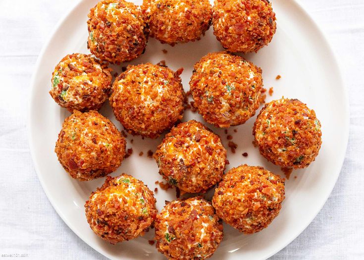 a white plate topped with meatballs on top of a table