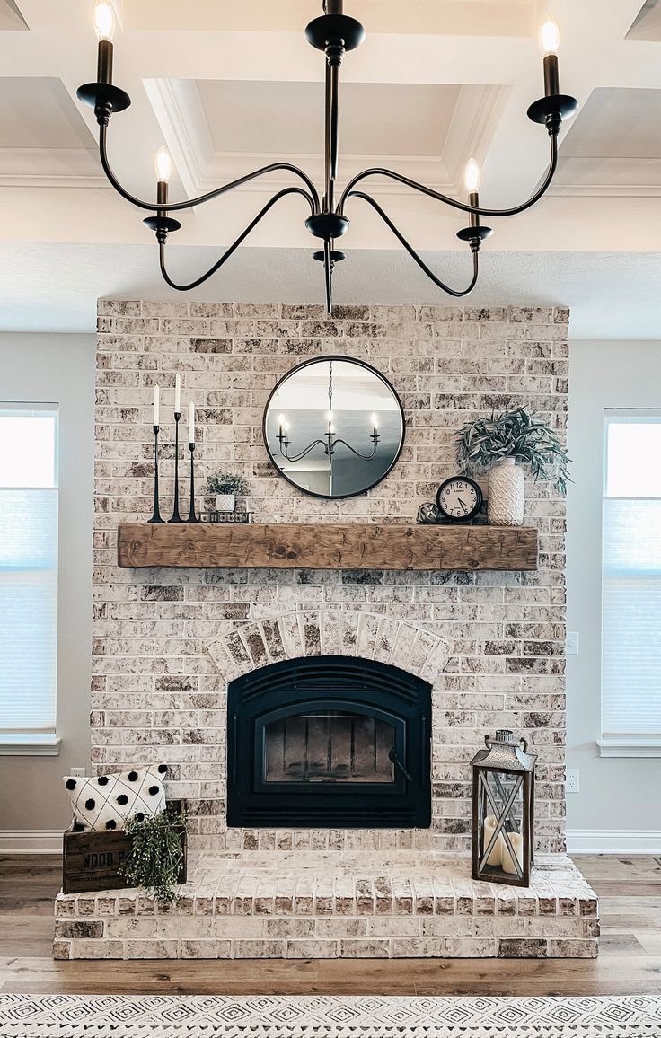 a living room filled with furniture and a fire place under a mirror on top of a mantle