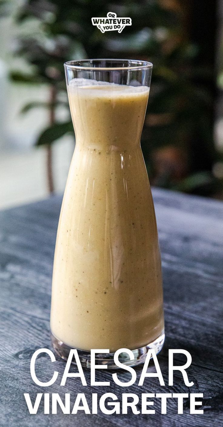 a glass filled with liquid sitting on top of a wooden table