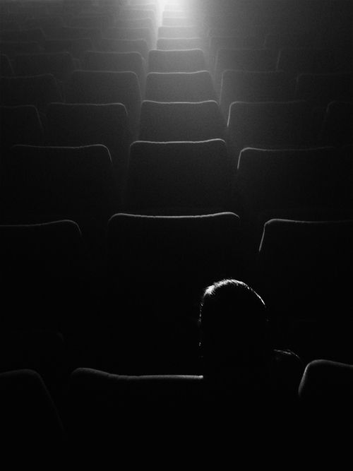 a person is sitting in an empty theater