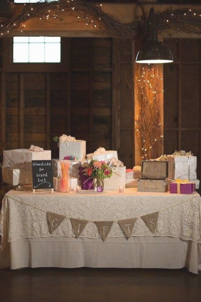 a table topped with lots of gifts under lights