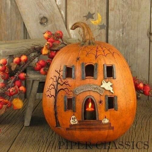 a pumpkin with an image of a house carved into it's side on the facebook page