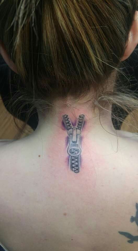 a woman with a tattoo on her back neck