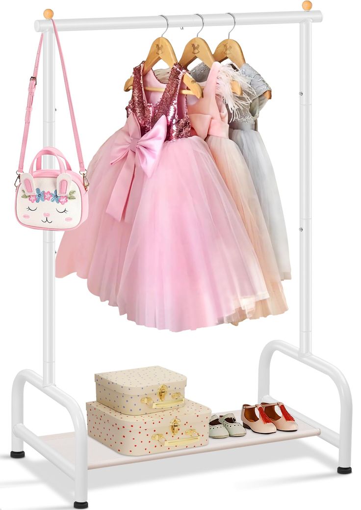 a white rack with pink dresses and shoes hanging on it's sides next to a purse