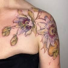 a woman's shoulder with flowers on it