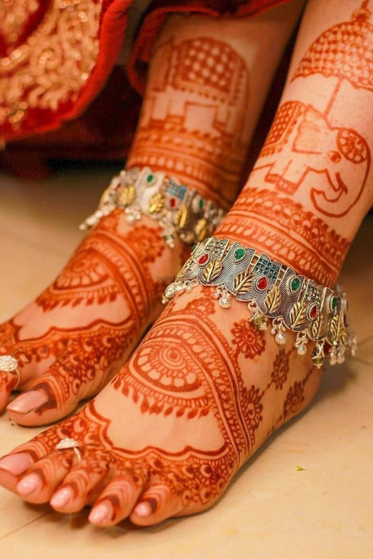 the feet are decorated with henna and jewels