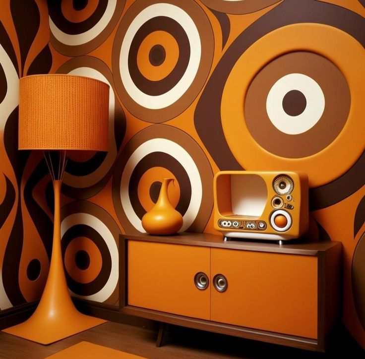 an orange and brown living room with speakers on the side table next to a lamp