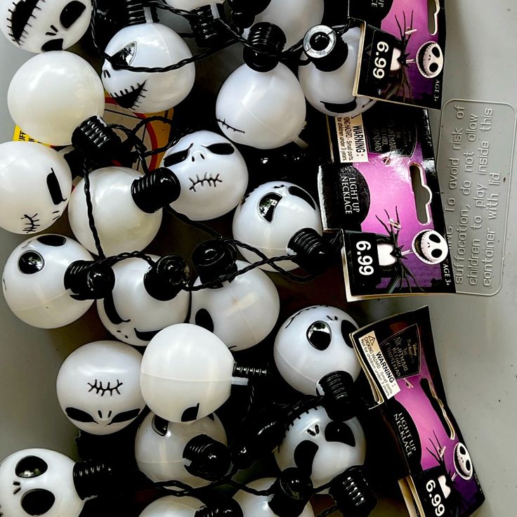 there are many white and black balls with faces on them