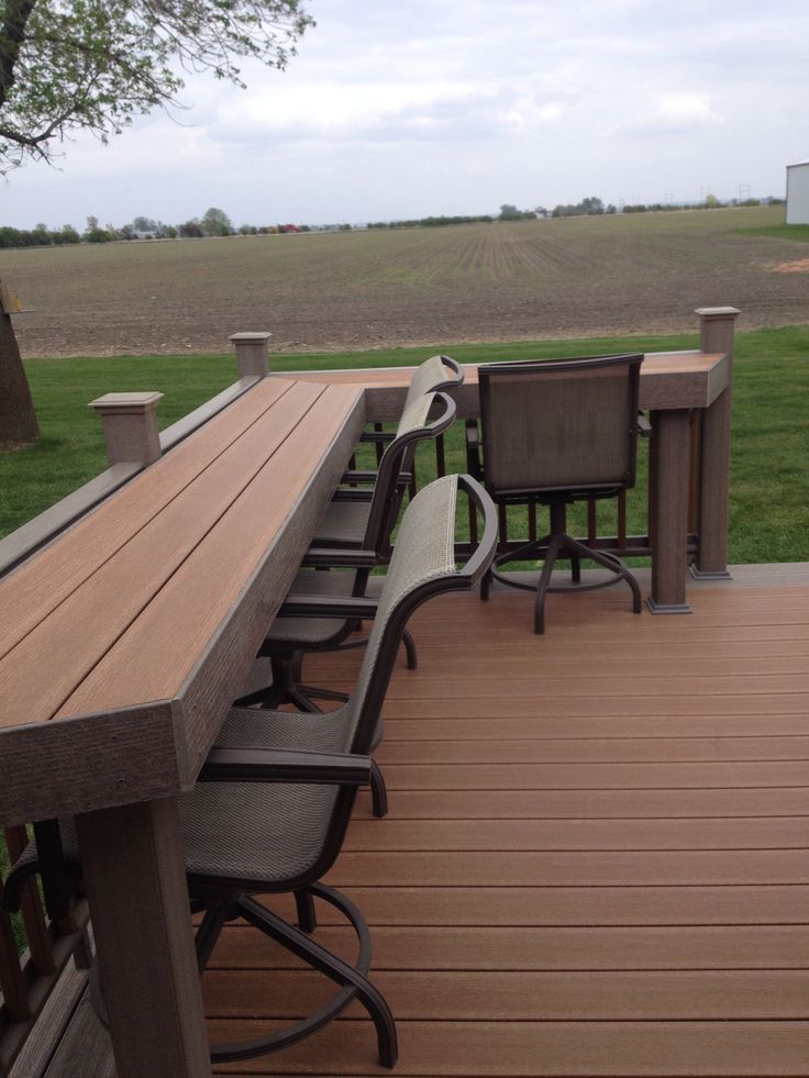 a wooden deck with chairs on it and the words diy written in front of them